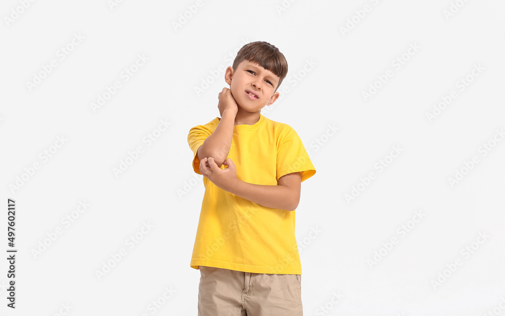 Little boy scratching himself on white background Little boy scratching himself on white background