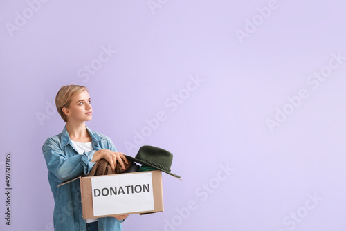 Young woman holding box wit...