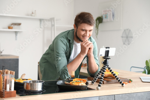 Young man watching cooking ...