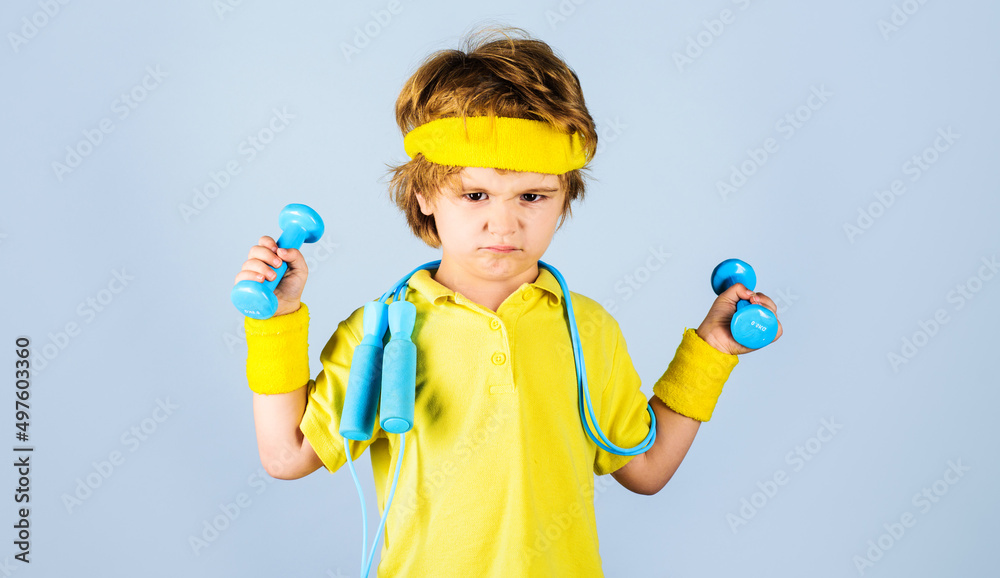 Child sportsman. Kid boy with skipping rope lifting dumbbells. Children fitness. Healthy childhood. Child sportsman. Kid boy with skipping rope lifting dumbbells. Children fitness. Healthy childhood.