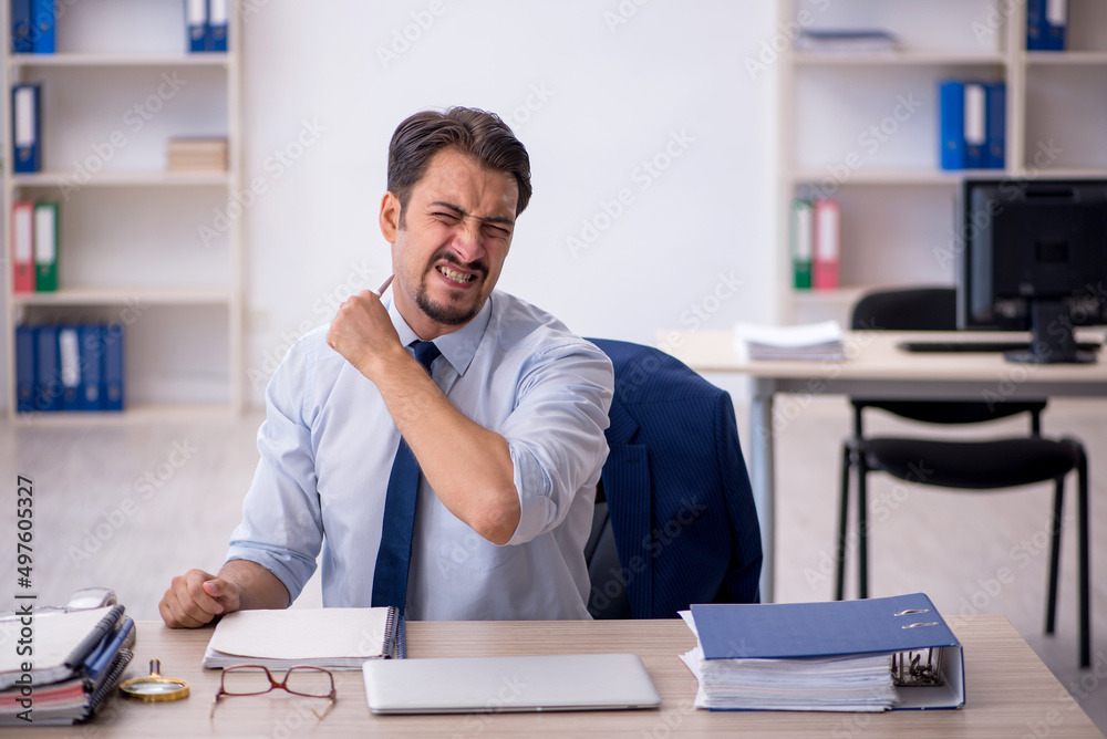 Young male employee working in the office Young male employee working in the office