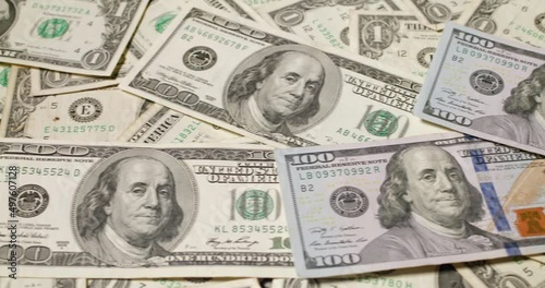 One hundred Dollar banknotes background. Pattern of 100 USD bills. Rotating background