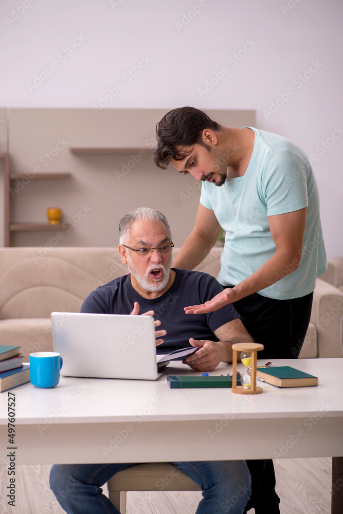 Grandfather and grandson at home with computer Grandfather and grandson at home with computer
