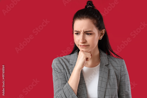 Worried young businesswoman...