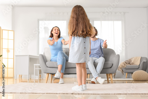Little daughter standing op...