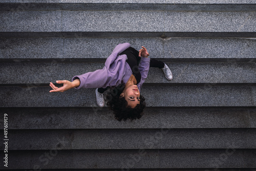 Fototapeta Naklejka Na Ścianę i Meble -  Young woman dance on stairs. Yoga.