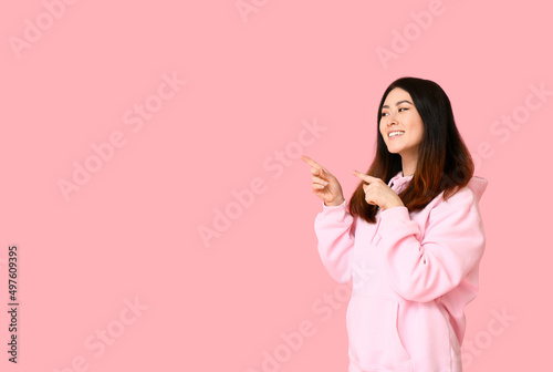 Young Asian woman in hoodie...