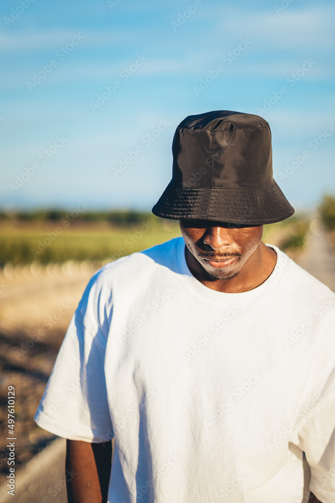 Portrait of a black man walking on a countryside road