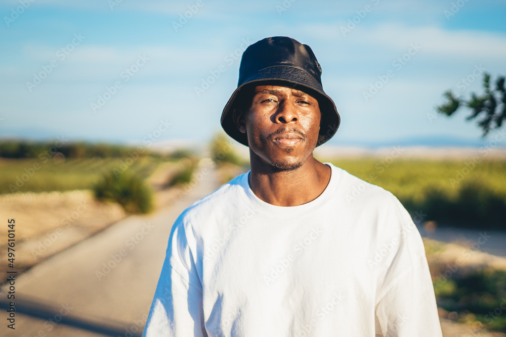 Portrait of a black man walking on a countryside road Portrait of a black man walking on a countryside road