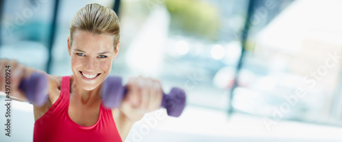 Im killing this workout. Cropped portrait of an attractive young woman working out with dumbbells.