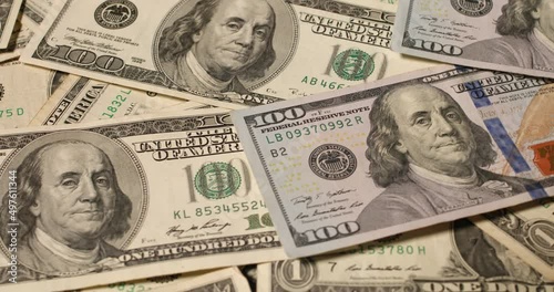 New and old 100 US Dollar banknotes rotating. Background and pattern of US Dollar currency