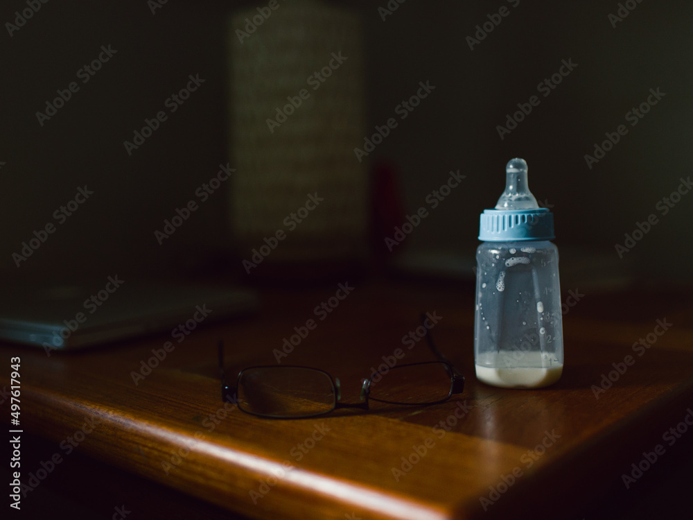 empty baby bottle on table in home empty baby bottle on table in home