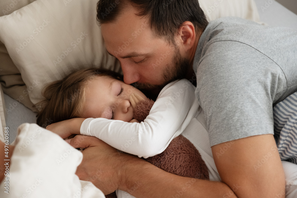 Father and daughter sleeping on bed together Father and daughter sleeping on bed together