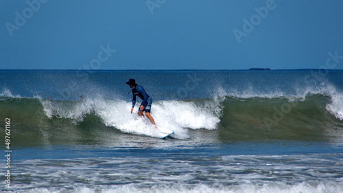 Canvas Print Man surfing off the beach in Tamarindo, Guanacaste, Costa Rica