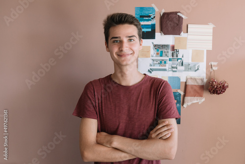 Smiling Designer In Front Of Colorful Vision Board photo