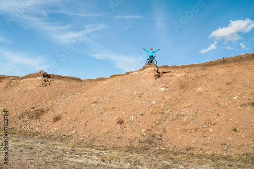 male cyclist is riding a gravel bike on cliff edge in Colorado prairie - Soapstone Prairie Natural Area