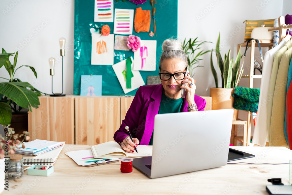 Fashion business woman calling by phone in office