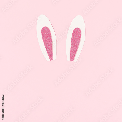 Bunny rabbit ears on pastel pink background.Happy Easter. Creative minimal Easter holiday concept. Holiday Easter celebration greeting card or idea. Flat lay