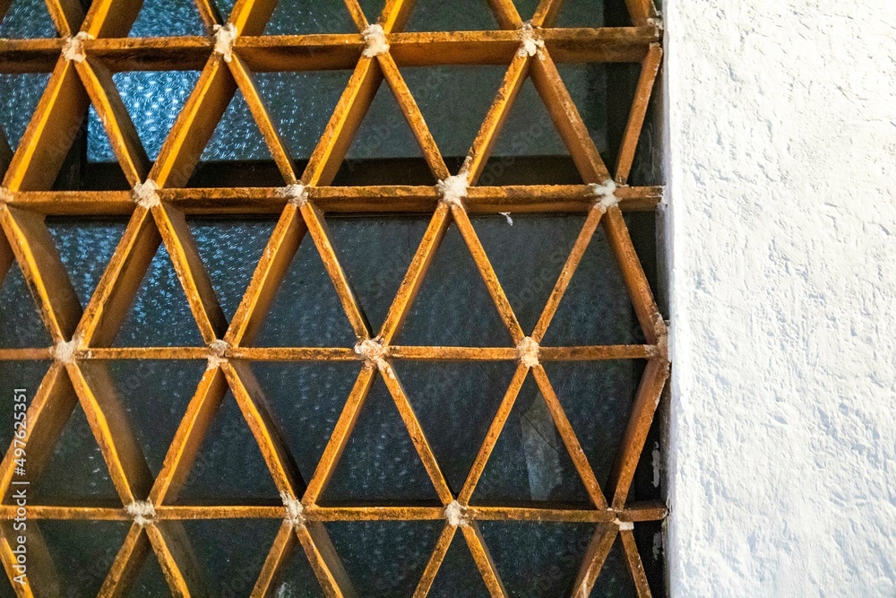 Triangular frame in front of frosted window Triangular frame in front of frosted window
