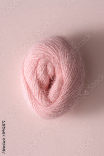 Skein of light pink wool in shape of female vagina photo