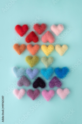 Multiple fuzzy hearts knitted from colorful yarn photo
