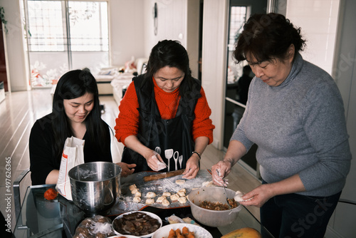 Chinese Women Make Dumplings At Home During Chinese New Year. photo