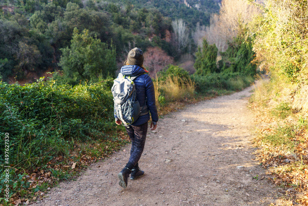 Woman walking in countryside in autumn