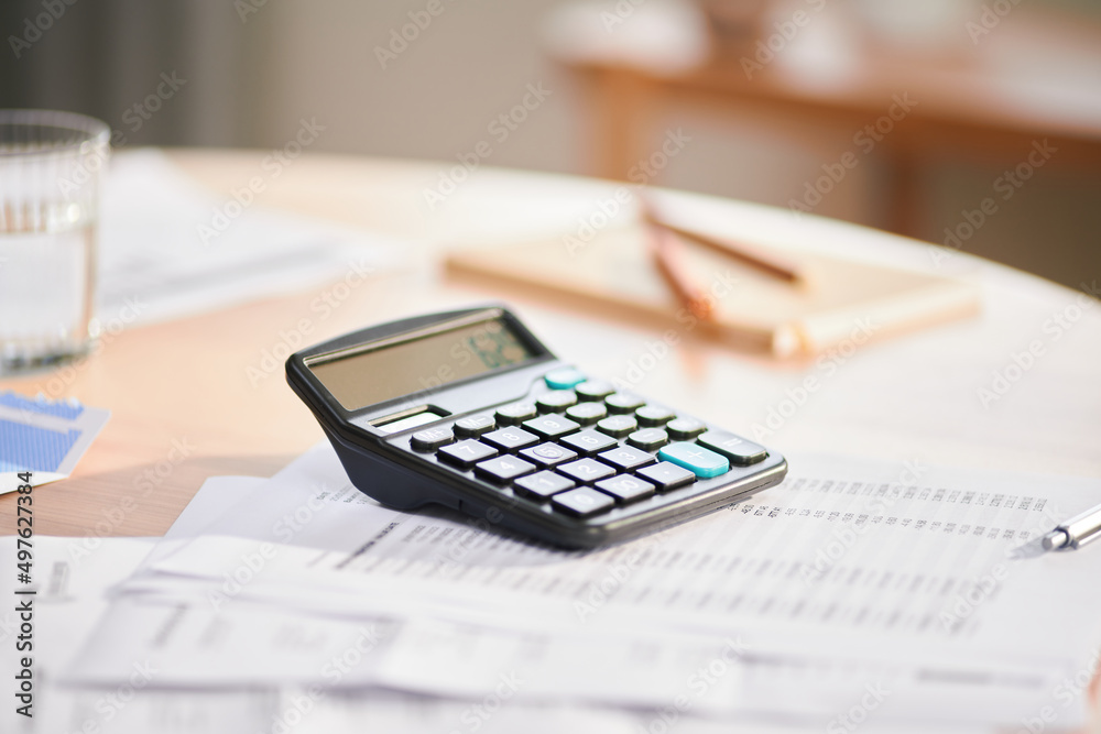 Calculator and documents on table Calculator and documents on table