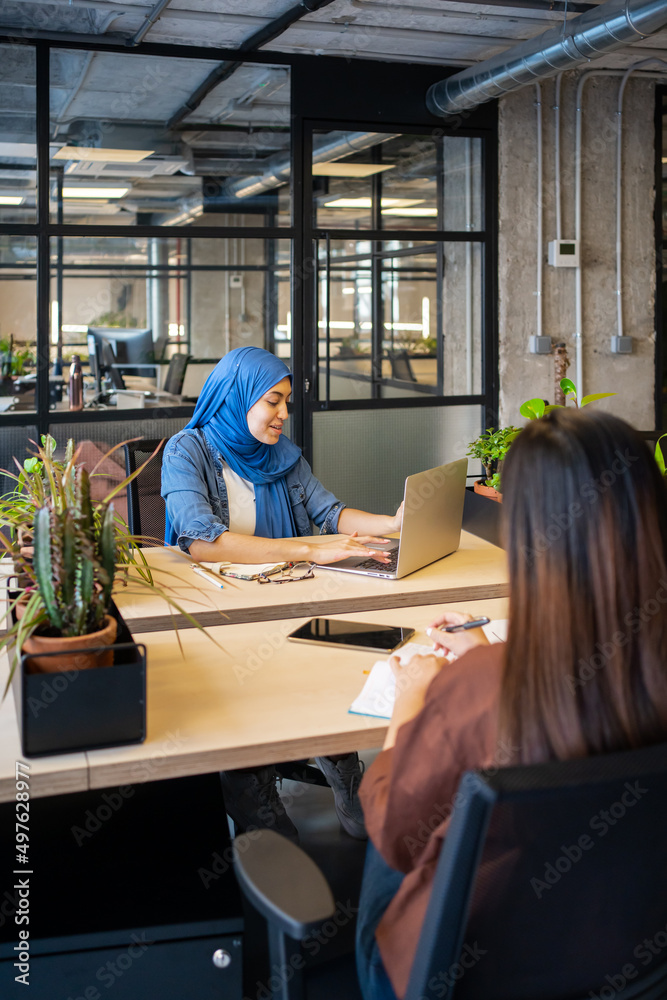 Muslim Woman Sitting Around The Table In A Co-Working. Muslim Woman Sitting Around The Table In A Co-Working.
