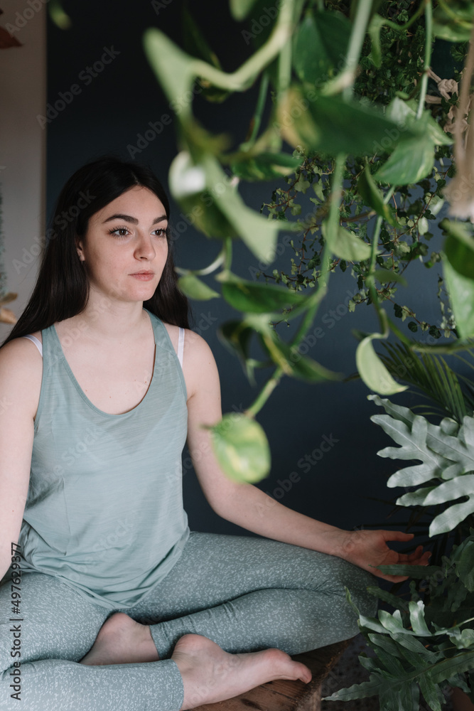Yoga Teacher Meditating In Studio On Wooden Table Yoga Teacher Meditating In Studio On Wooden Table