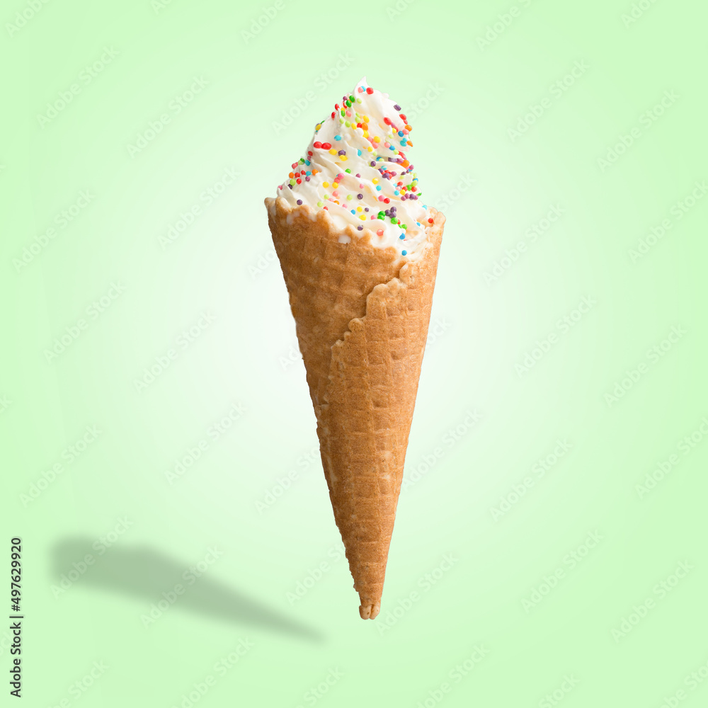 Vanilla ice cream with sweets in a waffle cone. Bright color, summer mood.