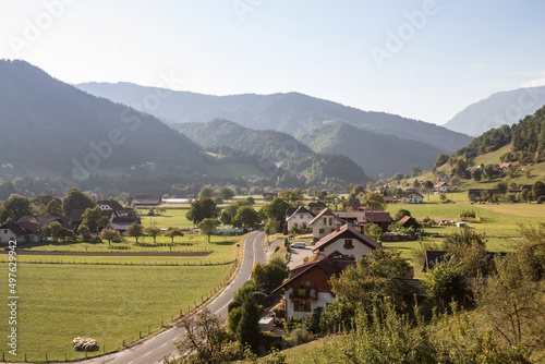 Aerial panorama of Ljubno ob Savinji, a typical central europea village of Slovenia, with individual houses, farmhouses, buildings, fields and julian alps mountains in a rural agricultural environment photo