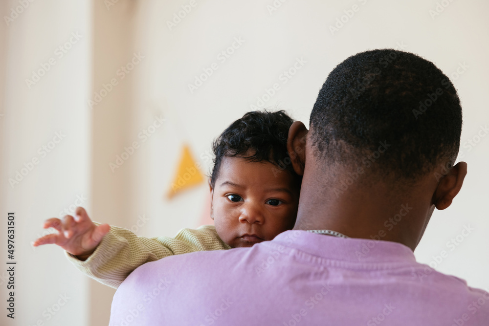 Father standing with baby at home