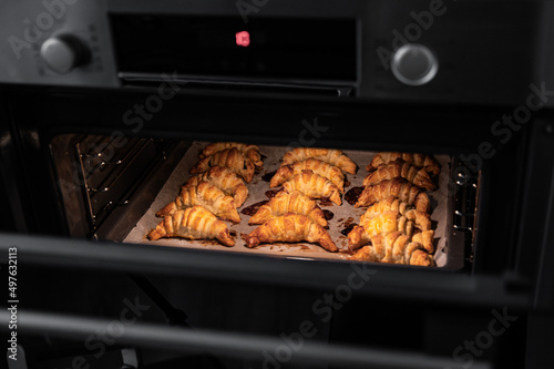 Hot oven with fresh buns photo