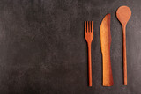 Wooden cutlery on dark background.