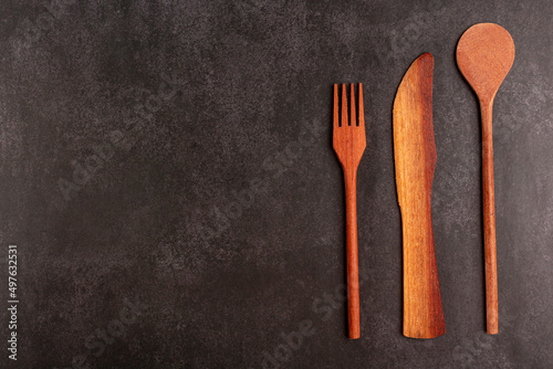Wooden cutlery on dark background.