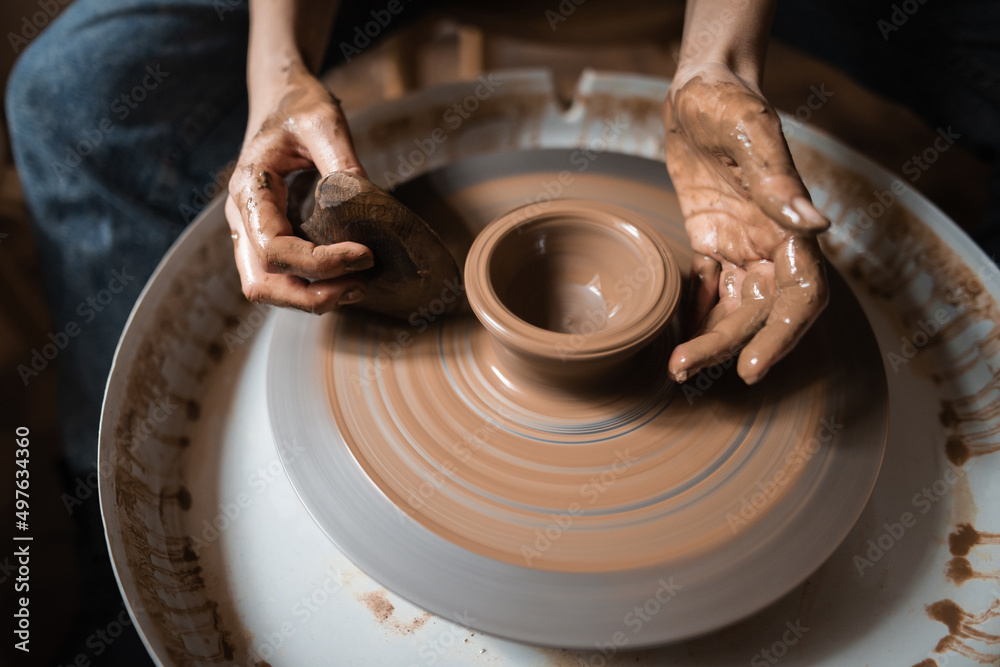 Female Potter Making Vase In Workshop With Natural Light Female Potter Making Vase In Workshop With Natural Light