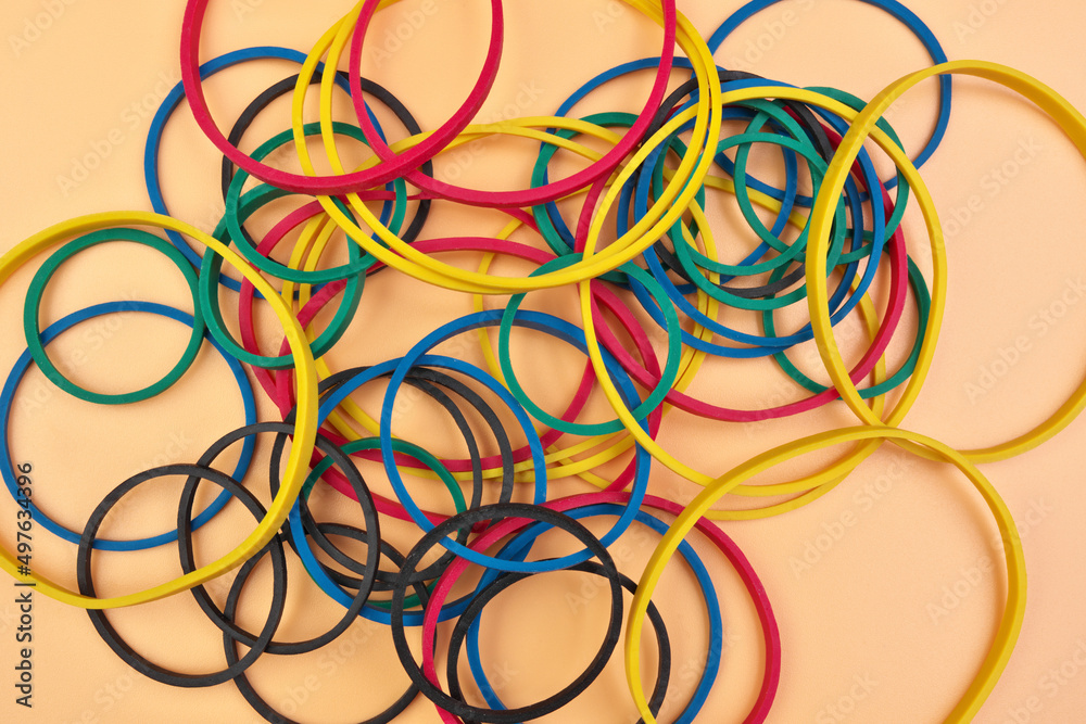Full Frame Image Flatlay of Multicolored Elastic Rubber Bands on a Cheerful Orange Pastel Background Full Frame Image Flatlay of Multicolored Elastic Rubber Bands on a Cheerful Orange Pastel Background