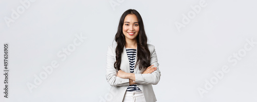 Business, finance and employment, female successful entrepreneurs concept. Confident nice smiling asian businesswoman cross arms chest confident, ready for meeting with financial partners photo