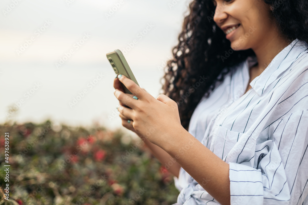 Young woman smiling using the smartphone