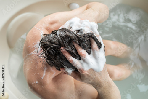 Man washing hair in spa bath photo