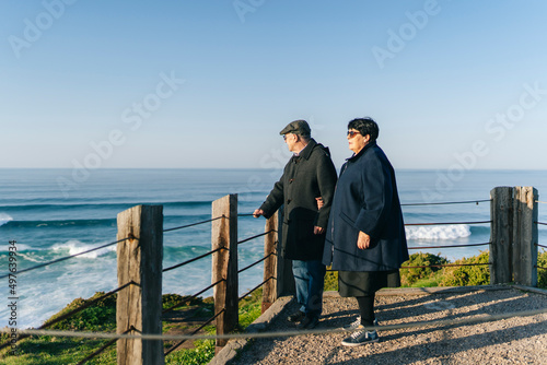 Elderly couple standing on embankment photo