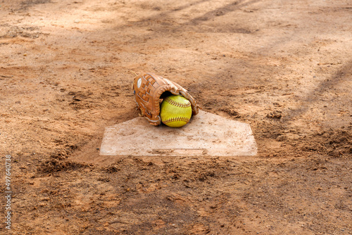 Old softball gloves and old softball balls on the homepage in a softball field.