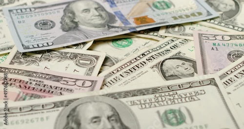 Rotating Dollar banknotes, background of US Dollar bills. Money pattern. 100, 50 and one US Dollar bills