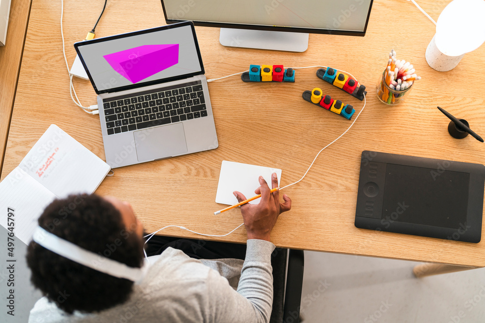 © Studio Marmellata/Stocksy - Male freelancer working on laptop and computer at home