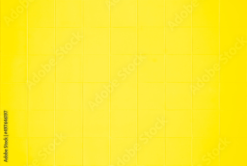 Yellow ceramic wall and floor tile abstract background. Design geometric for backdrop hospital wall, canteen and kitchen.