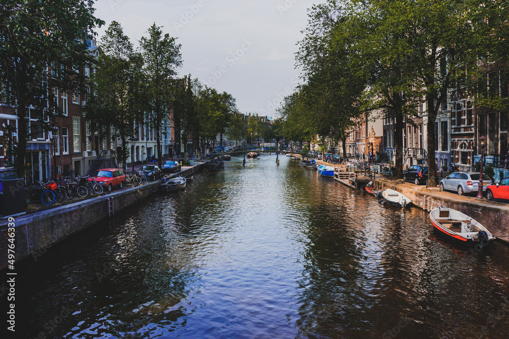 AMSTERDAM, NETHERLANDS - May 2019: Canal and St. Nicolas Church in Amsterdam.