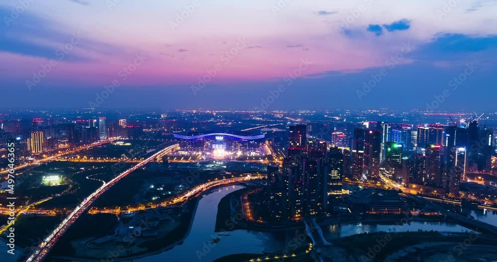 Aerial hyper lapse of Chengdu Cityscape at twilight  with office buildings and traffic on the road