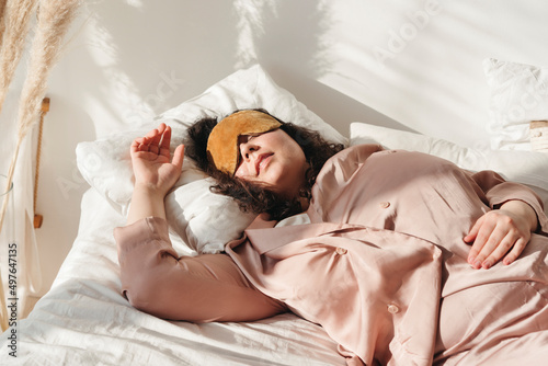 Woman using sleep mask. photo