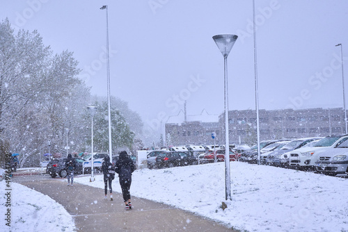 Pamplona, Navarra Spain april 01 2022, Surprise snowfall in early spring, people on the way to school Marists photo